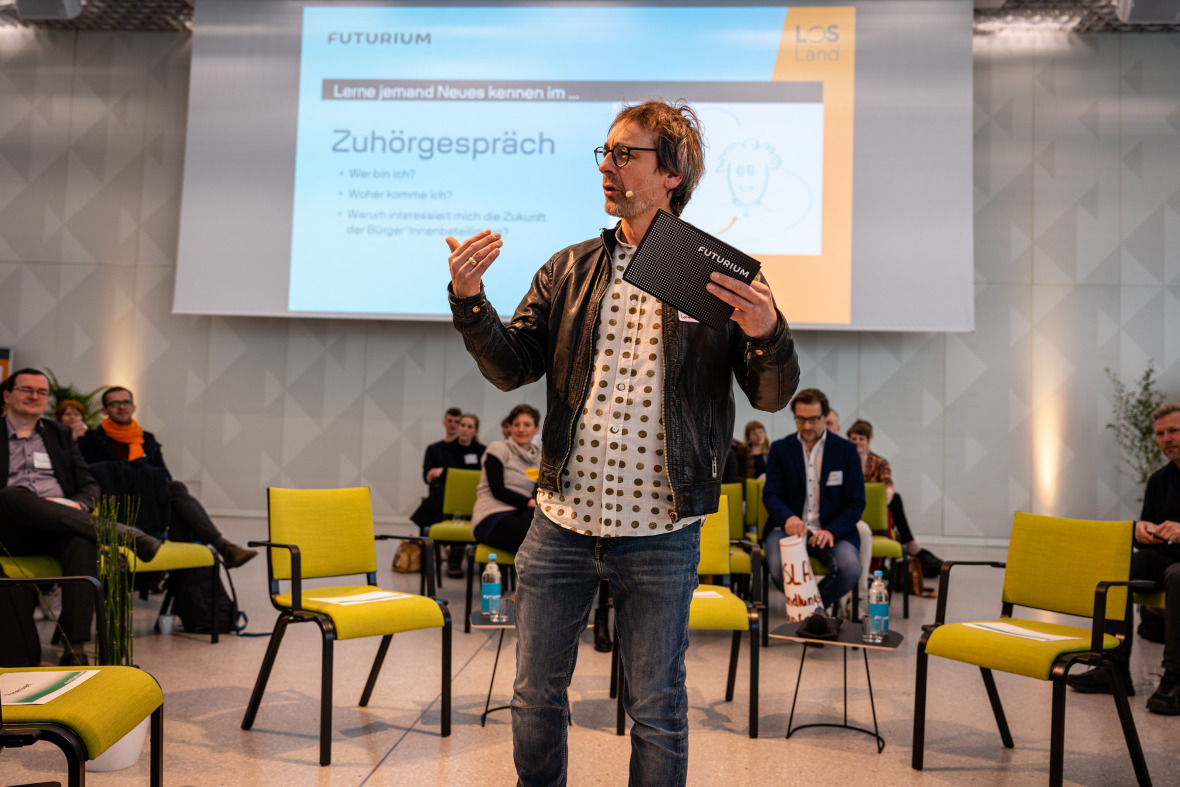 Moderator Robert Pakleppa erklärt, wie das interaktive Beteiligungs-Hub funktioniert.